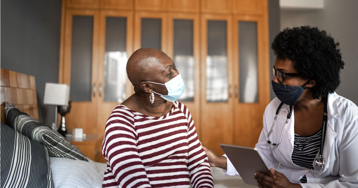 cancer patient meets with clinical care provider
