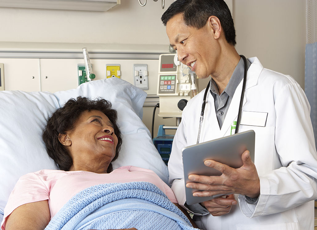 Asian doctor talking to female patient