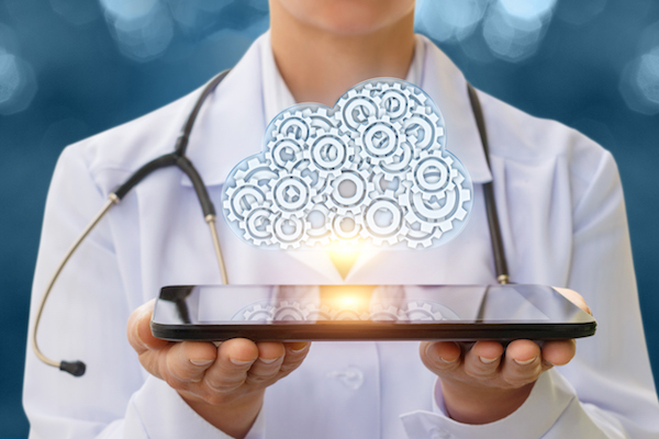 Doctor holding a tablet projecting holographic cloud.