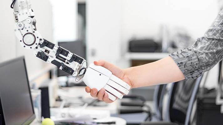 Robot shaking hands with a human.