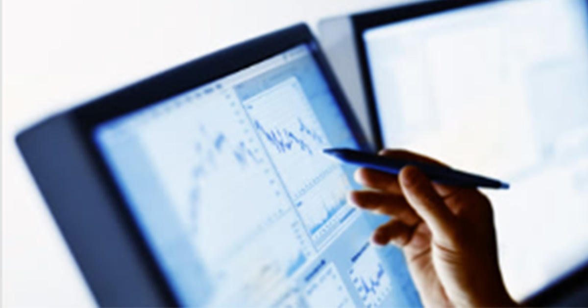 Hand with pen pointing at display screen