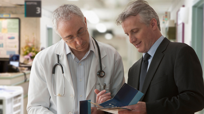 Executive talking to doctor.