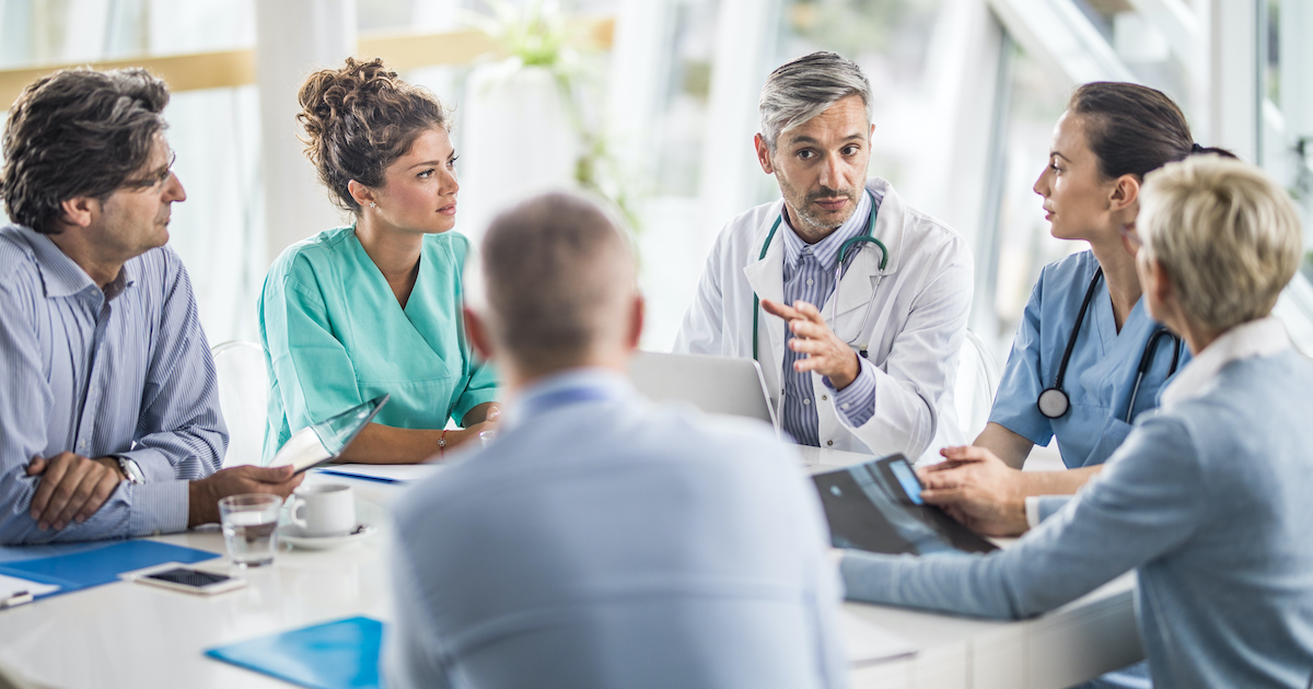 Doctors, nurses and healthcare executives meeting around a table
