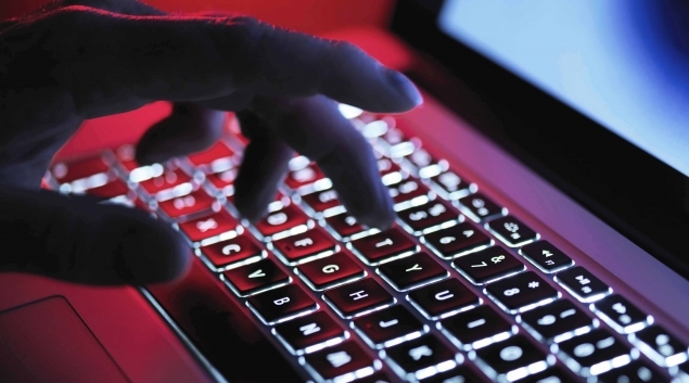 Hand typing on backlit keyboard
