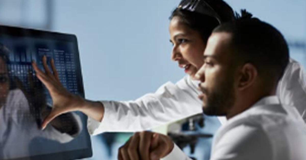 Healthcare workers looking at a monitor