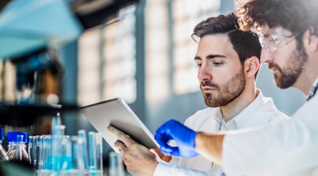 Lab coworkers with a tablet