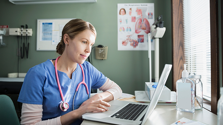 Woman doctor using a computer.