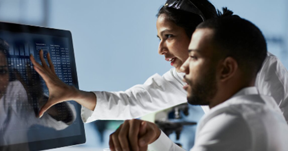 Healthcare workers looking at display screen
