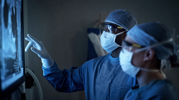 Surgeons looking at display