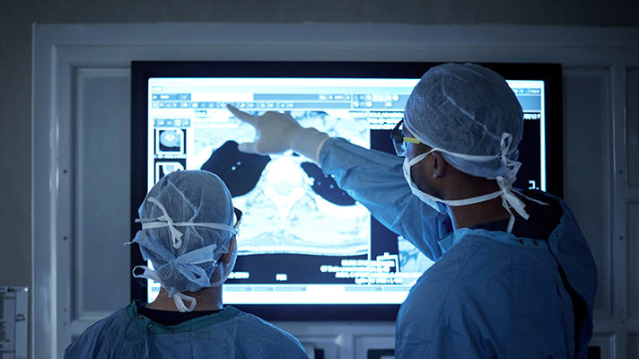 Doctors looking at a monitor.