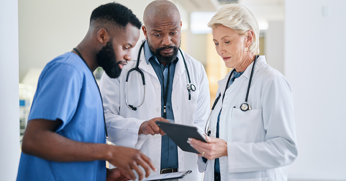 Group of healthcare workers looking at a tablet