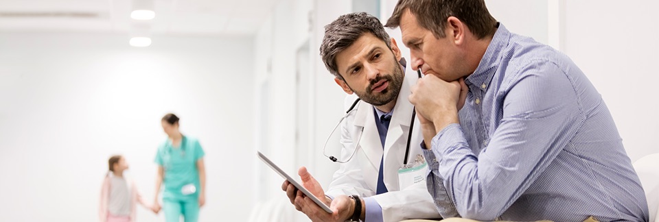 Doctor and person in shirt looking at tablet