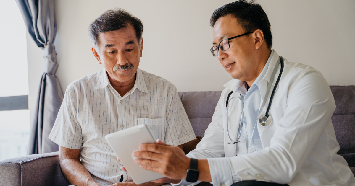 A doctor discussing a patient's health findings using a digital tablet.