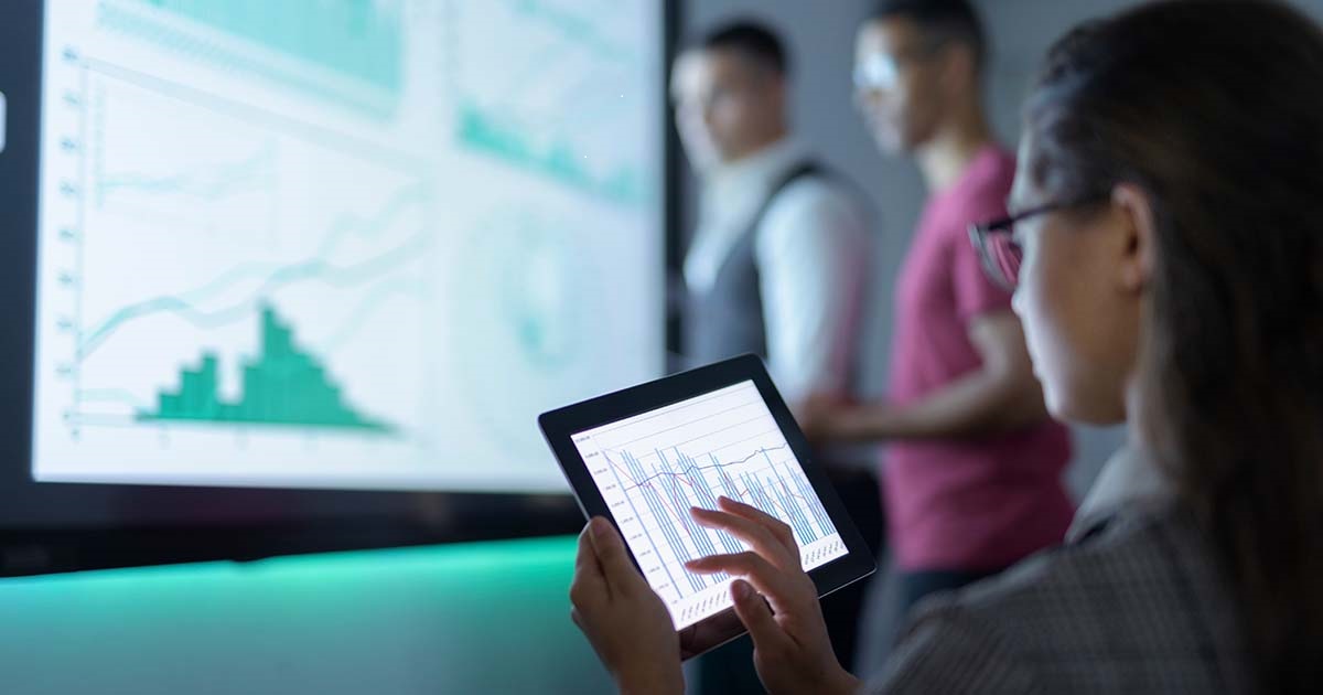 Businessperson viewing graphs on a tablet