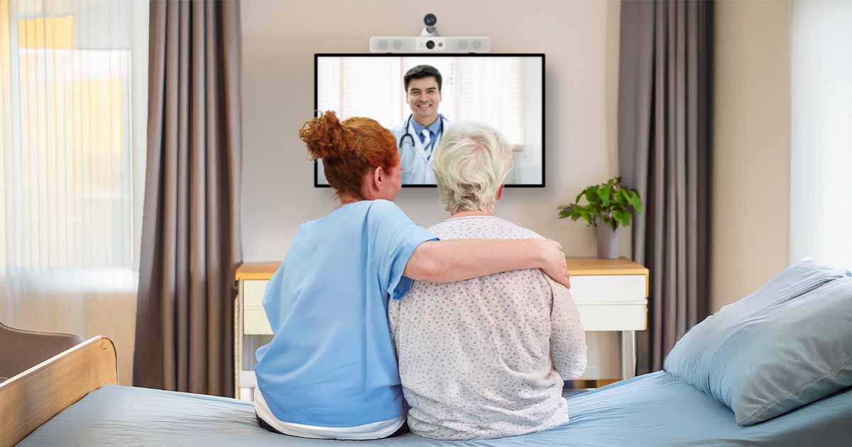 Healthcare worker and patient watching doctor on screen