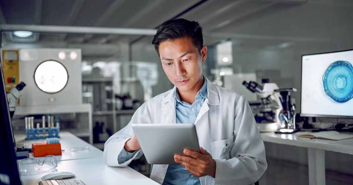 Doctor in lab looking at tablet