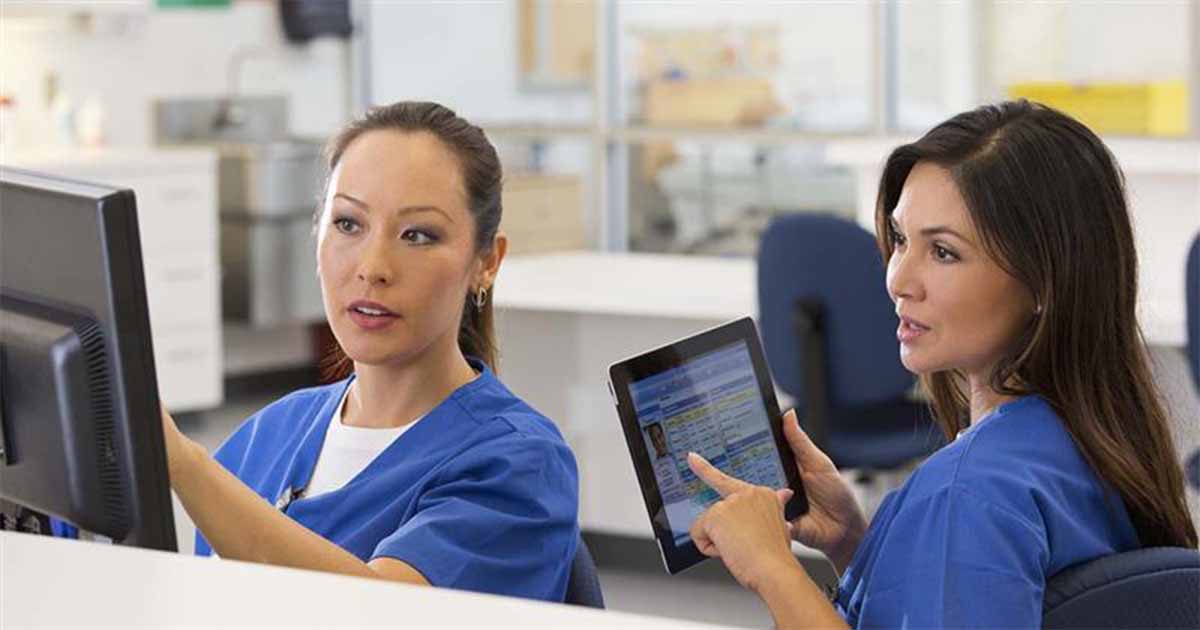 Nurses talking and pointing at device screens