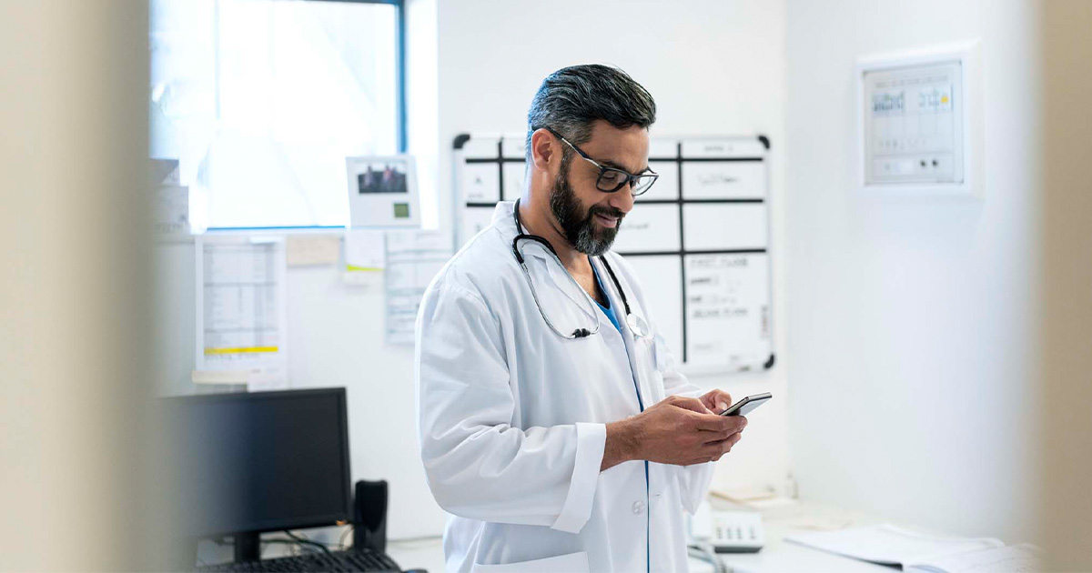 Doctor looking at smartphone