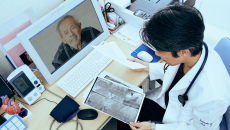 A doctor relaying a patient's heart X-ray findings via teleconsultation