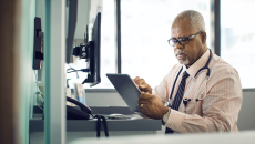 A doctor using a digital tablet