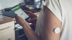 Person wearing monitoring device reviews app results