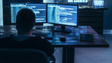 worker looking at dual monitors