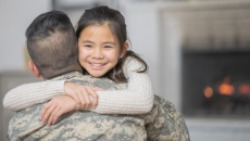 U.S. service member hugs his child