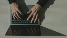 Hands on a laptop keyboard