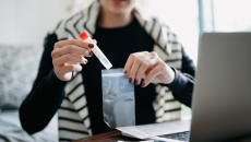A person taking a COVID-19 self test