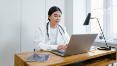 A medical professional at a computer
