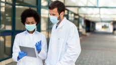 Two doctors looking at an EHR on a tablet