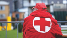 A man in a Red Cross jacket