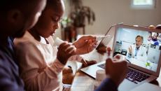 Adult and child laptop telehealth visit