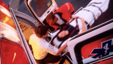 A patient being taken away into an ambulance vehicle.