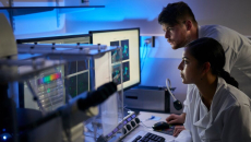 Researchers analysing data from two desktop computer screen