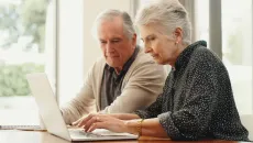 Couple using laptop