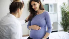Healthcare worker talking to pregnant person