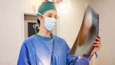 A surgeon examining an X-ray image 