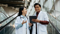 Doctors looking at tablet and talking