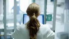 Healthcare worker looking at computer monitor