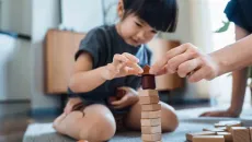 Child and adult playing with blocks
