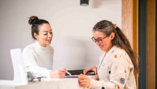 Person filling out forms for receptionist