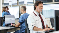 Healthcare workers using computers in an office