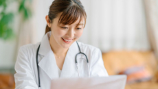 A doctor reviewing a patient's medical record on a laptop computer