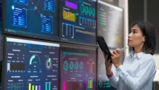 Healthcare employee assesses analytics dashboards
