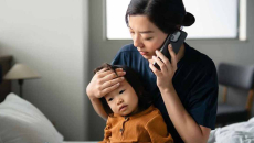 Person holding child talking on the phone