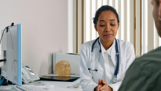 Patient signing off on treatment plan with doctor in office
