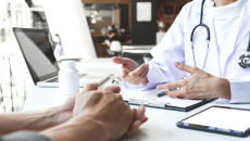 A doctor and patient in a physical clinic consultation