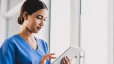 Nurse trains on EHR processes with tablet