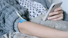 Patient at home with IV and phone